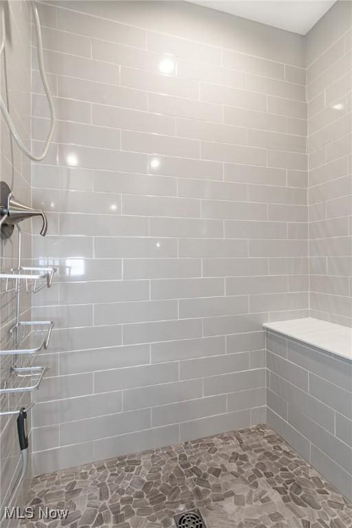 864 Woodside Dr, Westlake, OH 44145 - bathroom featuring tiled shower and stone finish flooring