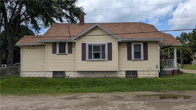 1549 Quimby Ave SW, Canton, OH 44706 - view of side of property with a chimney, a porch, and roof with shingles
