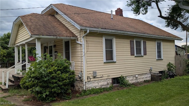 1549 Quimby Ave SW, Canton, OH 44706 - view of side of home with a chimney, a lawn, covered porch, and a shingled roof