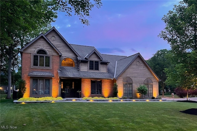 5502 Quail Run, North Olmsted, OH 44070 - view of front facade featuring a lawn, a shingled roof, and brick siding