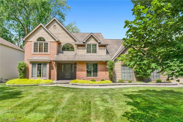 5502 Quail Run, North Olmsted, OH 44070 - view of front of house featuring a front yard, brick siding, and a shingled roof