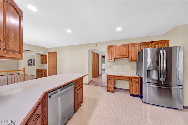 5502 Quail Run, North Olmsted, OH 44070 - kitchen with stainless steel appliances, light countertops, recessed lighting, brown cabinetry, and light tile patterned floors