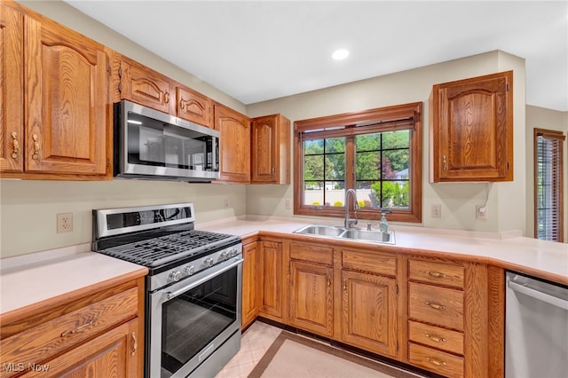 5502 Quail Run, North Olmsted, OH 44070 - kitchen featuring appliances with stainless steel finishes, light countertops, brown cabinetry, and recessed lighting