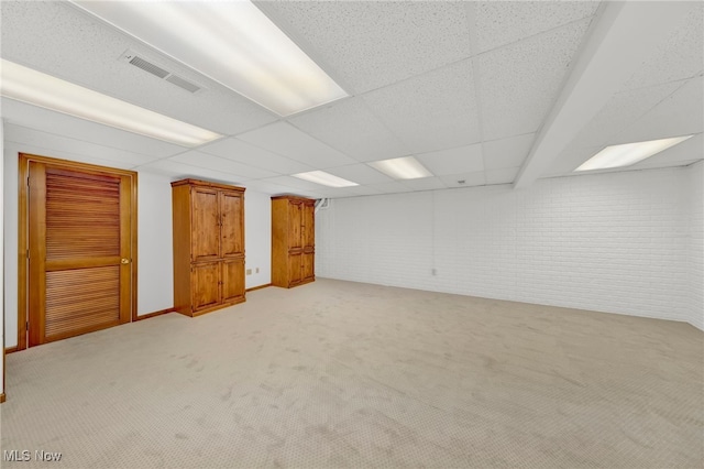 5502 Quail Run, North Olmsted, OH 44070 - finished below grade area with light carpet, brick wall, and a paneled ceiling