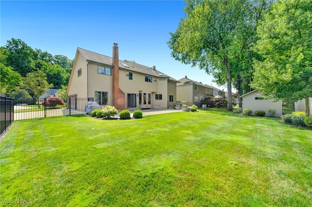 5502 Quail Run, North Olmsted, OH 44070 - rear view of house with a chimney, a patio area, and french doors