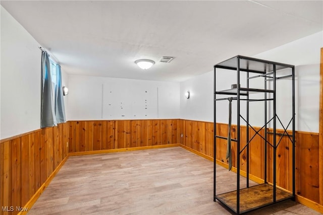 302 Bender Ave, Akron, OH 44312 - spare room with wainscoting, wood finished floors, and wooden walls