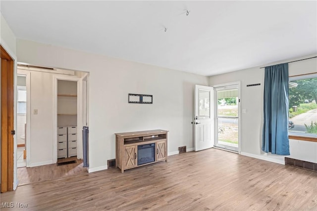 302 Bender Ave, Akron, OH 44312 - unfurnished living room featuring wood finished floors and a barn door