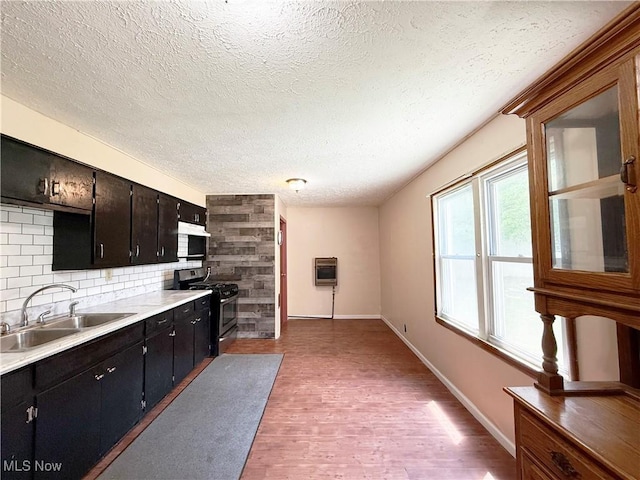 5048 Grove Ave, Lorain, OH 44055 - kitchen with gas stove, a textured ceiling, heating unit, light wood-style flooring, and light countertops