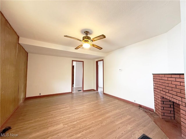 5048 Grove Ave, Lorain, OH 44055 - unfurnished living room with light wood finished floors, a fireplace, and ceiling fan