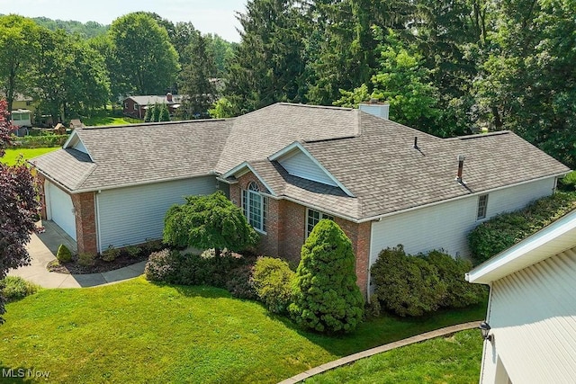 215 Bailey Ct, Doylestown, OH 44230 - view of front facade with brick siding, a front yard, an attached garage, and a shingled roof
