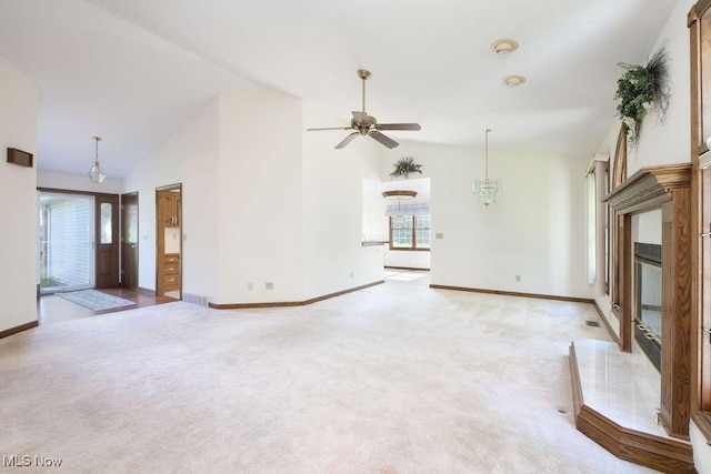 215 Bailey Ct, Doylestown, OH 44230 - unfurnished living room featuring a glass covered fireplace, light carpet, a ceiling fan, and high vaulted ceiling