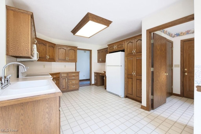 215 Bailey Ct, Doylestown, OH 44230 - kitchen featuring freestanding refrigerator, light countertops, brown cabinetry, and range