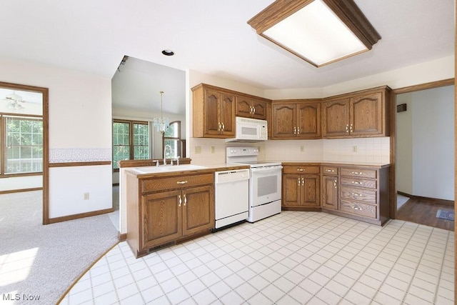 215 Bailey Ct, Doylestown, OH 44230 - kitchen featuring white appliances, brown cabinets, tasteful backsplash, and light countertops