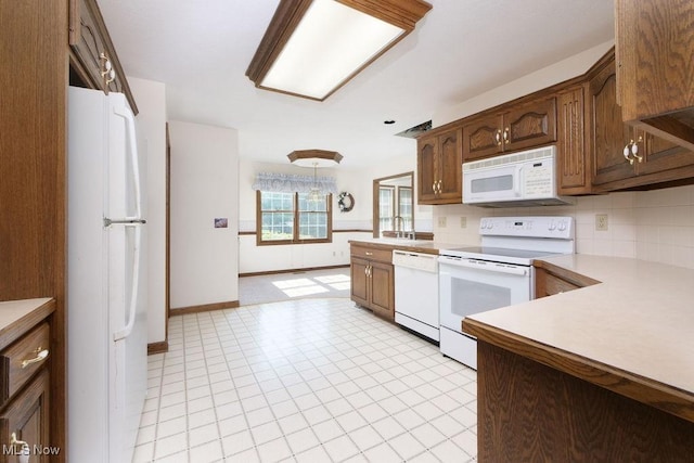 215 Bailey Ct, Doylestown, OH 44230 - kitchen with white appliances, decorative backsplash, and light countertops
