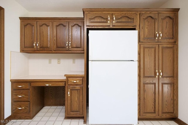 215 Bailey Ct, Doylestown, OH 44230 - kitchen with freestanding refrigerator, light countertops, backsplash, and brown cabinets