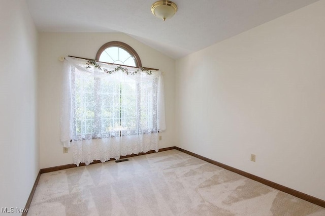 215 Bailey Ct, Doylestown, OH 44230 - unfurnished room with light carpet and vaulted ceiling
