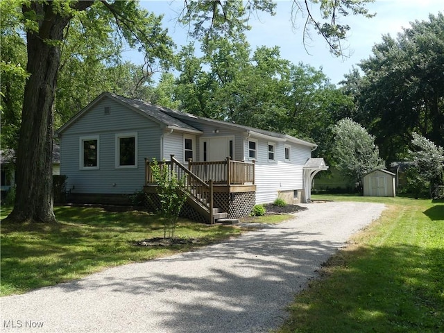 6069 Hyde St, Mentor, OH 44060 - view of front facade featuring a shed, driveway, and a front lawn