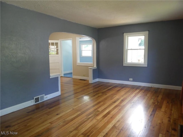 6069 Hyde St, Mentor, OH 44060 - empty room with arched walkways and wood-type flooring