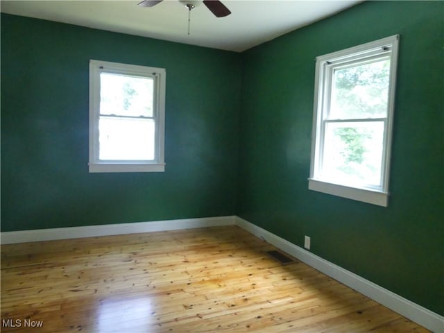 6069 Hyde St, Mentor, OH 44060 - empty room featuring plenty of natural light, hardwood / wood-style floors, and ceiling fan