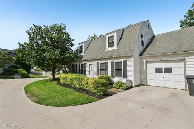 8080 Harbor Crk Unit 503, Mentor On The Lake, OH 44060 - view of property exterior featuring a garage, driveway, a shingled roof, and a gambrel roof