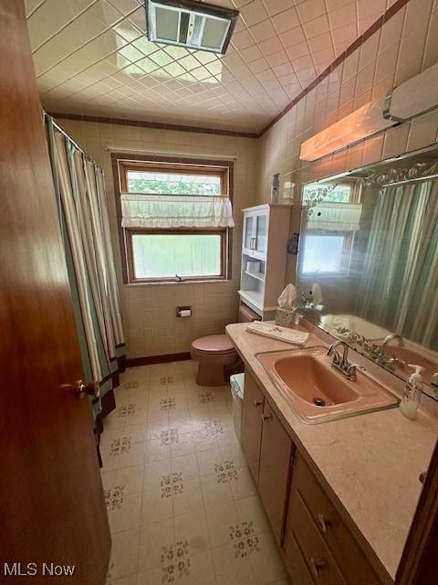 211 Donnell St, Weirton, WV 26062 - bathroom with vanity, a shower with shower curtain, and tile patterned floors
