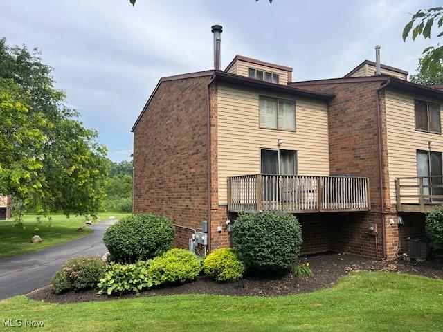 2157 Penguin Ave, Akron, OH 44319 - back of house with brick siding and a lawn