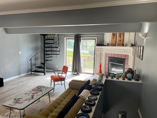 2157 Penguin Ave, Akron, OH 44319 - living room with stairs, wood finished floors, crown molding, and a tile fireplace