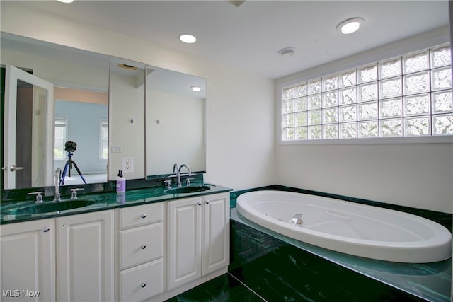 181 Seminary St, Berea, OH 44017 - bathroom with double vanity, plenty of natural light, and a jetted tub