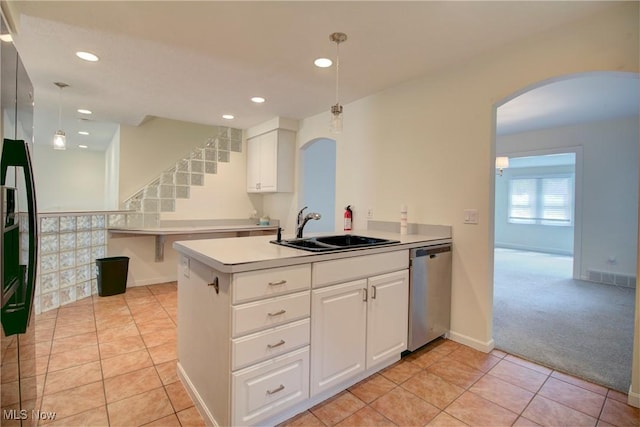 181 Seminary St, Berea, OH 44017 - kitchen with dishwasher, arched walkways, recessed lighting, and white cabinets