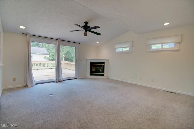 181 Seminary St, Berea, OH 44017 - unfurnished living room featuring a glass covered fireplace, vaulted ceiling, carpet flooring, ceiling fan, and recessed lighting