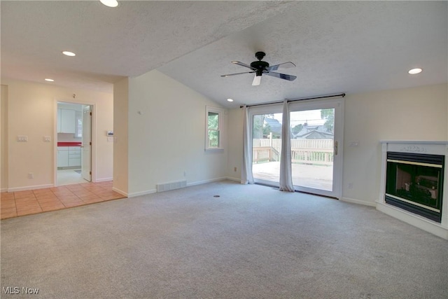 181 Seminary St, Berea, OH 44017 - unfurnished living room featuring carpet flooring, recessed lighting, a ceiling fan, a glass covered fireplace, and lofted ceiling