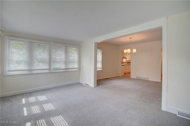 181 Seminary St, Berea, OH 44017 - unfurnished living room with a chandelier and carpet floors