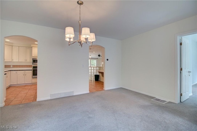 181 Seminary St, Berea, OH 44017 - spare room with arched walkways, light carpet, a chandelier, and light tile patterned flooring