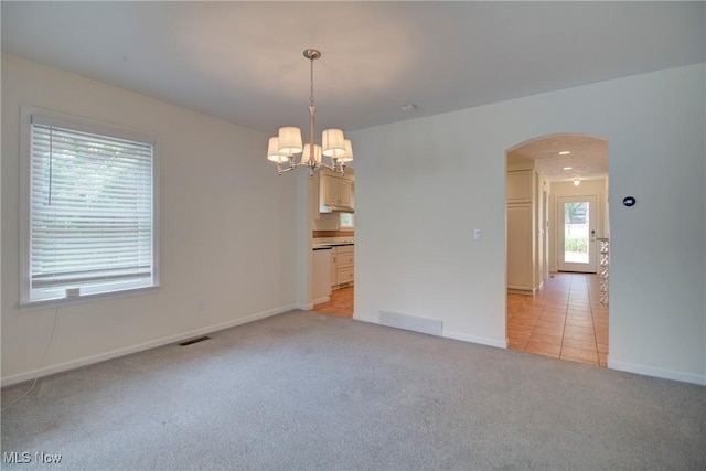 181 Seminary St, Berea, OH 44017 - spare room featuring arched walkways, a chandelier, and light colored carpet