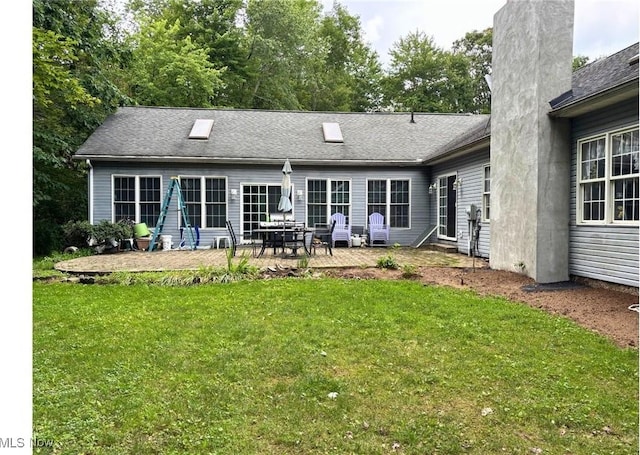 611 Wainwright Rd SE, New Philadelphia, OH 44663 - back of property featuring a chimney, a patio, and a yard