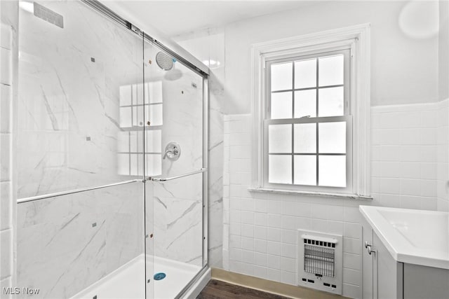 2324 Scholl Rd, University Heights, OH 44118 - full bath with heating unit, tile walls, a marble finish shower, vanity, and a wainscoted wall