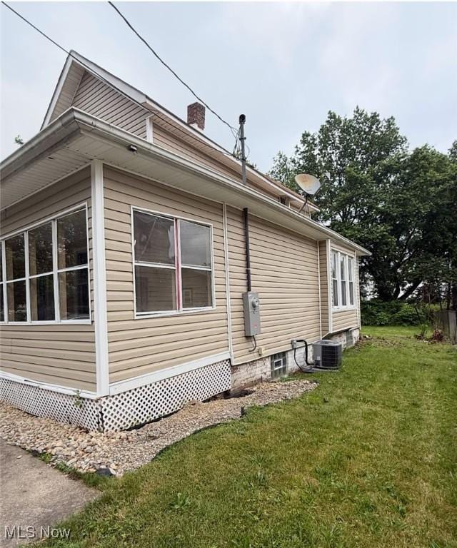 1063 Raymond St, Akron, OH 44307 - view of home's exterior featuring a yard and a chimney
