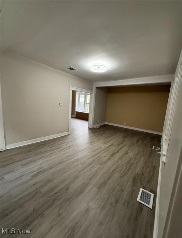 1063 Raymond St, Akron, OH 44307 - unfurnished room with baseboards and dark wood-type flooring
