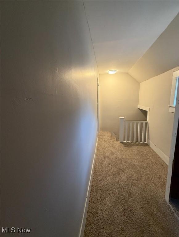 1063 Raymond St, Akron, OH 44307 - hall featuring carpet, vaulted ceiling, and an upstairs landing