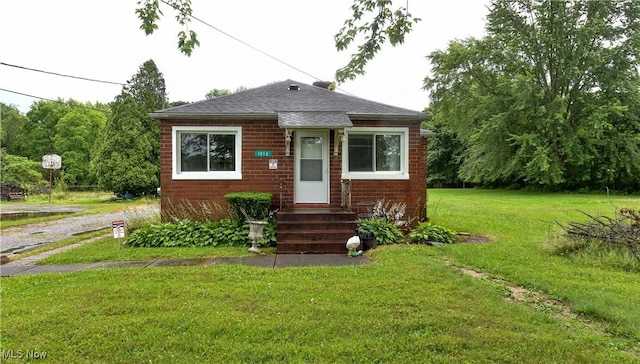 1212 State Route 7 NE, Brookfield, OH 44403 - bungalow-style house with a front lawn, roof with shingles, and entry steps