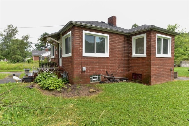 1212 State Route 7 NE, Brookfield, OH 44403 - view of home's exterior with brick siding, a chimney, and a lawn
