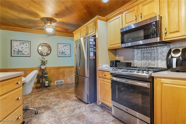 2970 Meadow Ln, Youngstown, OH 44511 - kitchen with appliances with stainless steel finishes, light countertops, a ceiling fan, a wainscoted wall, and wood ceiling
