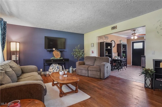 13774 Smith Goshen Rd, Beloit, OH 44609 - living area featuring wood finished floors, a textured ceiling, and ceiling fan