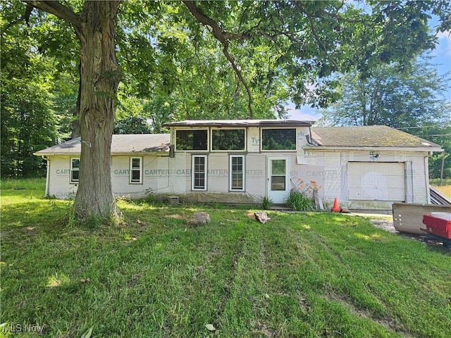 1070 US Highway 6, Rome, OH 44085 - view of front of home with a garage, a front lawn, and stucco siding