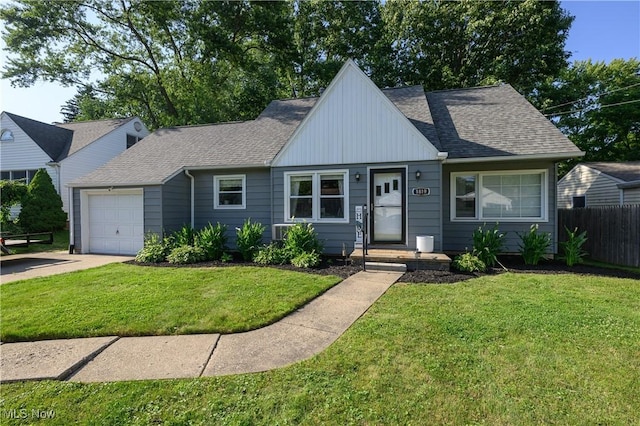 1819 49th St NW, Canton, OH 44709 - view of front facade with an attached garage, roof with shingles, and concrete driveway
