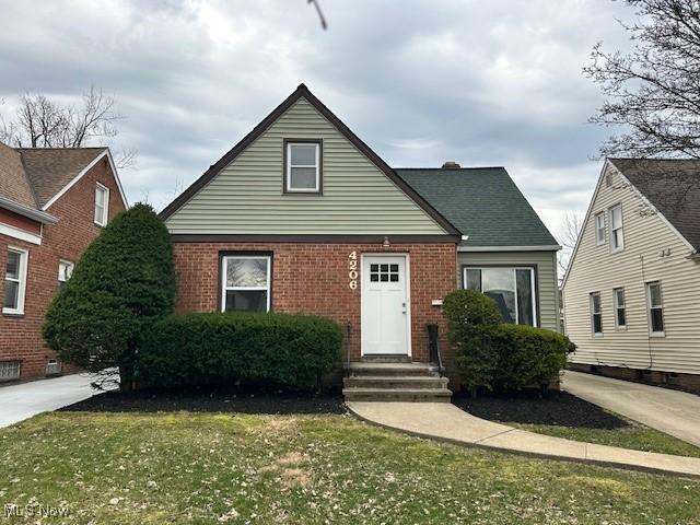 4206 Verona Rd, South Euclid, OH 44121 - bungalow featuring brick siding and a front lawn