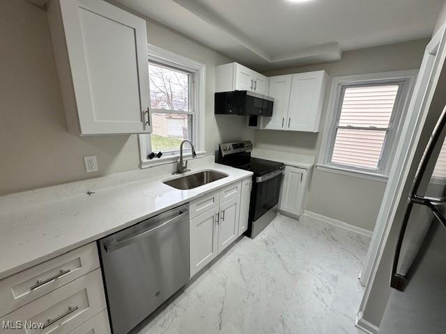 4206 Verona Rd, South Euclid, OH 44121 - kitchen featuring stainless steel appliances, white cabinetry, light countertops, and healthy amount of natural light