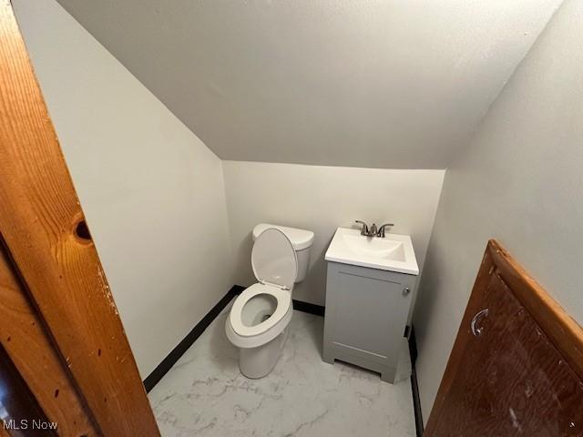 4206 Verona Rd, South Euclid, OH 44121 - bathroom with vanity, lofted ceiling, and marble finish flooring