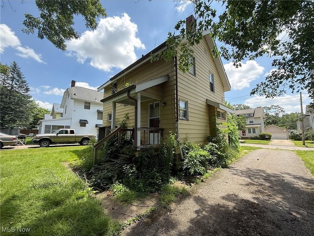 315 Superior St, Newton Falls, OH 44444 - view of home's exterior featuring a lawn and a chimney