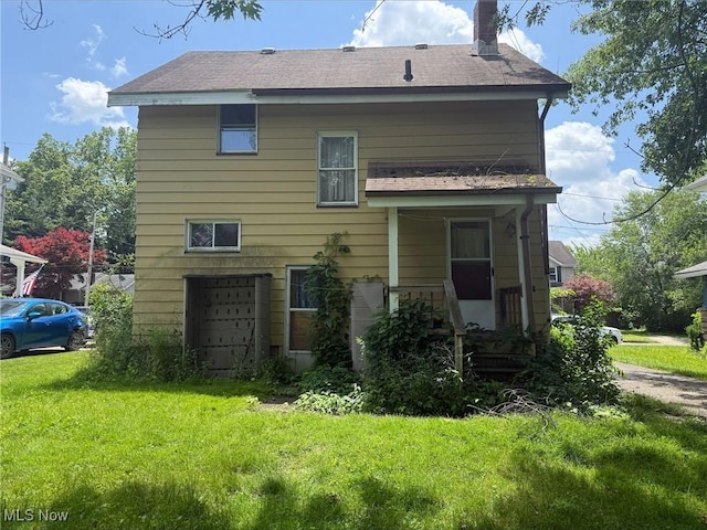 315 Superior St, Newton Falls, OH 44444 - rear view of property featuring a chimney, a yard, a garage, and roof with shingles
